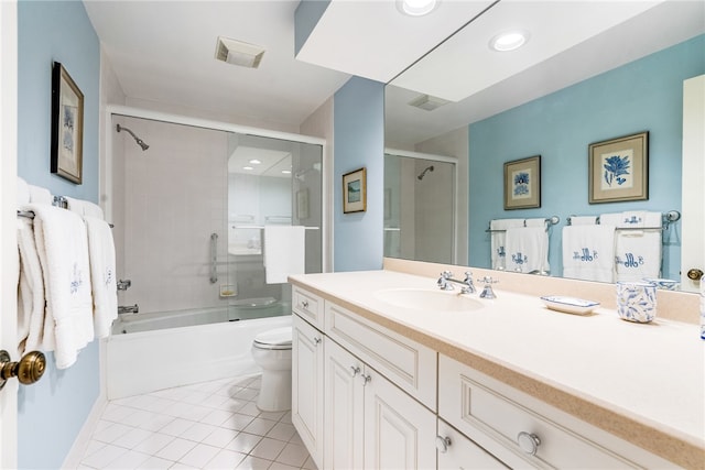 full bathroom with vanity, bath / shower combo with glass door, tile patterned floors, and toilet