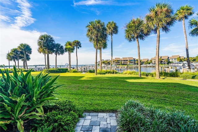 view of home's community featuring a yard and a water view