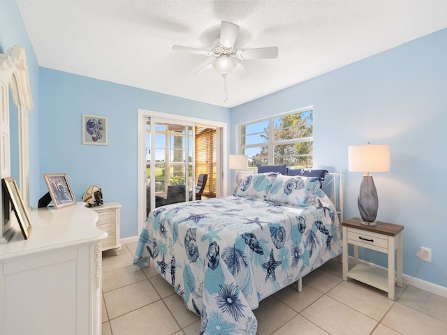 tiled bedroom with access to outside, a textured ceiling, and ceiling fan