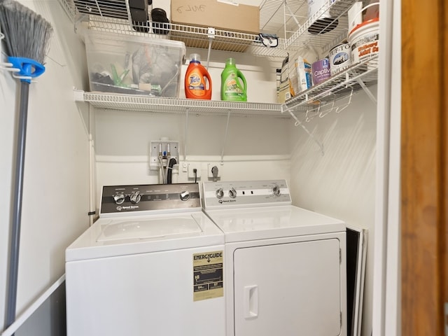 clothes washing area with separate washer and dryer