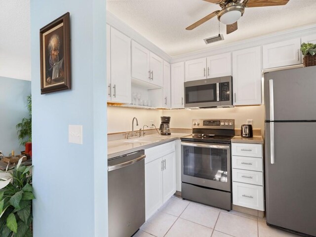 kitchen featuring white cabinetry, stainless steel appliances, and sink