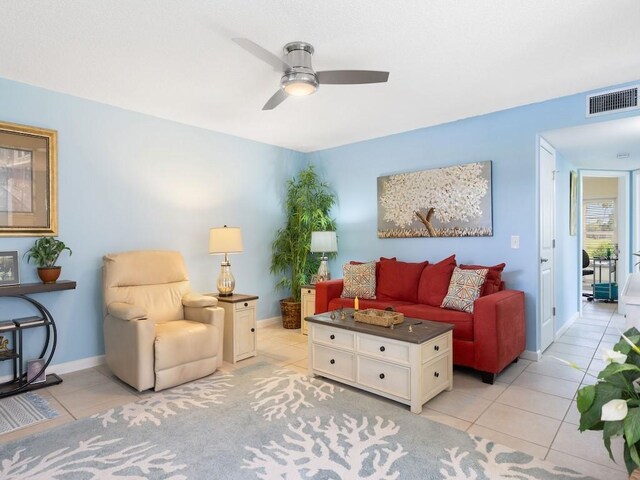 living room with ceiling fan and light tile patterned flooring