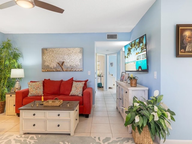 tiled living room with ceiling fan