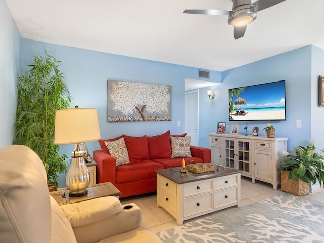 tiled living room with ceiling fan