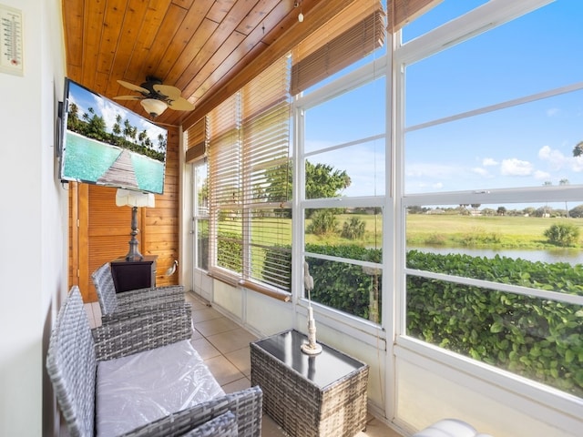 sunroom / solarium with a wealth of natural light, a water view, ceiling fan, and wood ceiling