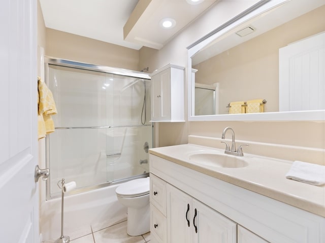 full bathroom with toilet, bath / shower combo with glass door, vanity, and tile patterned floors