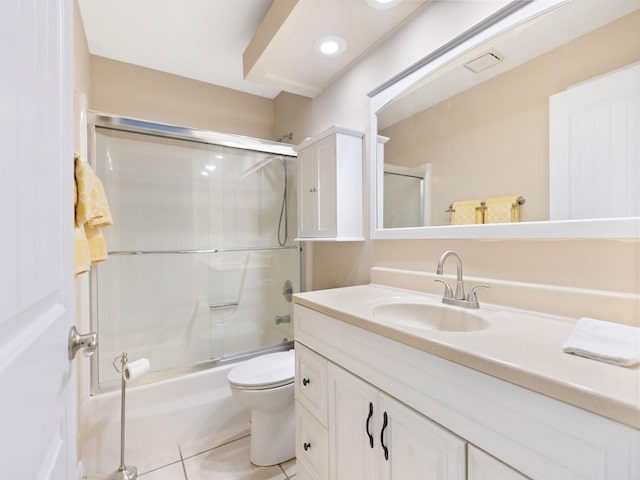 full bathroom with toilet, bath / shower combo with glass door, tile patterned floors, and vanity