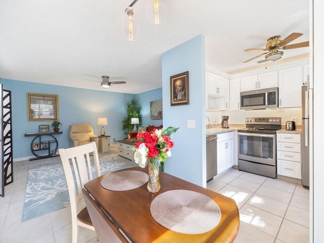 dining area featuring light tile patterned flooring and ceiling fan