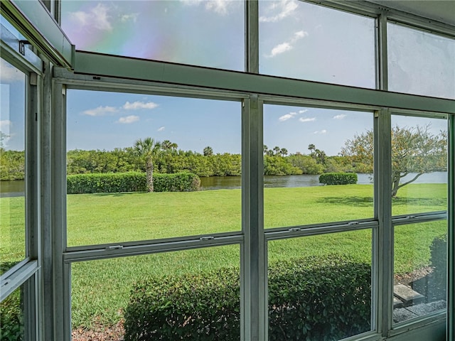 unfurnished sunroom featuring a water view and a healthy amount of sunlight