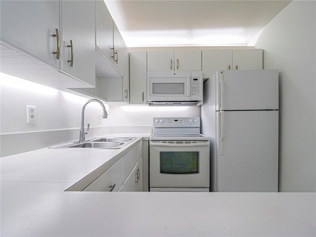 2800 Indian River Blvd Unit L2, Vero Beach, FL 32960 - kitchen featuring white appliances, a sink, and light countertops