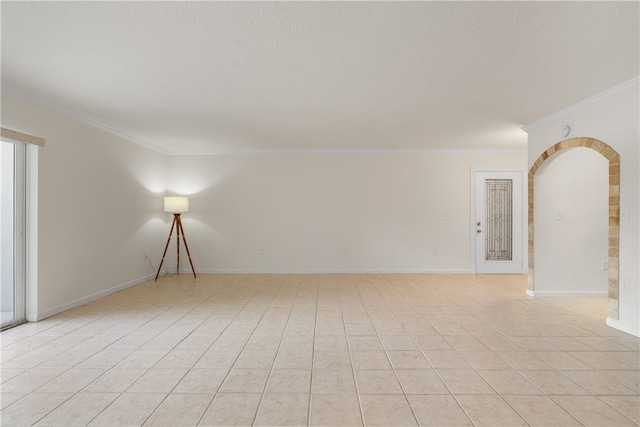 tiled empty room featuring crown molding