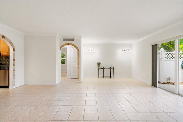 spare room with light tile patterned floors and ornamental molding