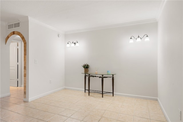 spare room with light tile patterned floors and crown molding