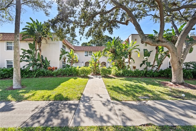 mediterranean / spanish-style house with a front yard