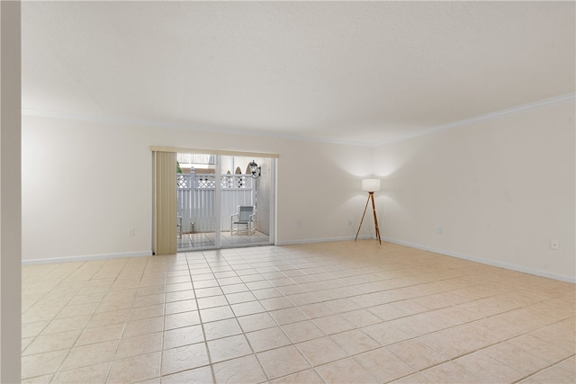 tiled spare room featuring a chandelier and crown molding