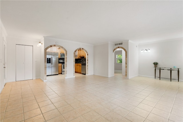 tiled spare room featuring crown molding