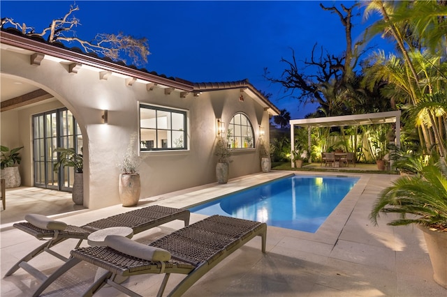 pool at night with a patio