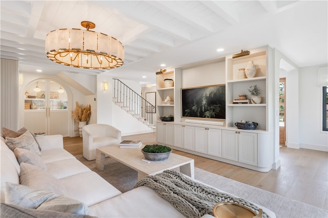 living room featuring beam ceiling and light wood-type flooring