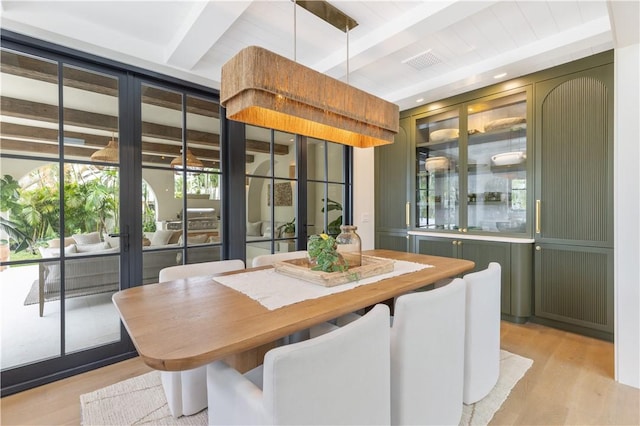 601 Flamevine Ln, Vero Beach, FL 32963 - dining space featuring beamed ceiling, light wood-style floors, and french doors