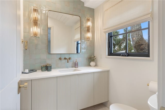 bathroom featuring decorative backsplash, vanity, and toilet