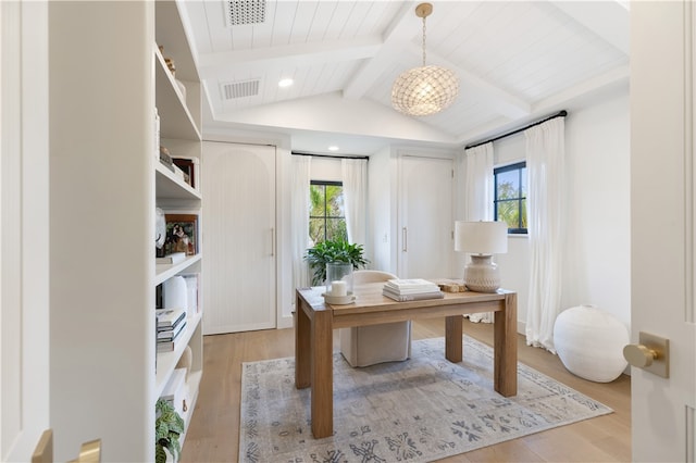 home office with lofted ceiling with beams, light hardwood / wood-style floors, and a healthy amount of sunlight