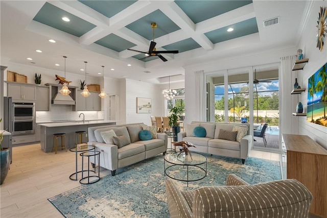living room featuring coffered ceiling, light wood-style flooring, beamed ceiling, recessed lighting, and a ceiling fan