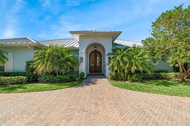 815 Starboard Dr, Vero Beach, FL 32963 - property entrance with a yard and french doors