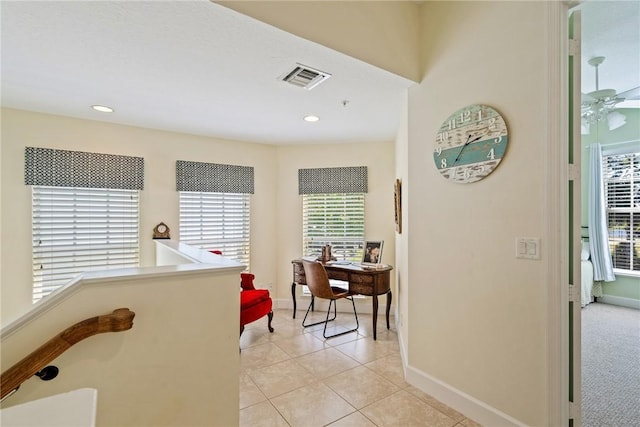 corridor featuring light tile patterned floors, visible vents, baseboards, and recessed lighting