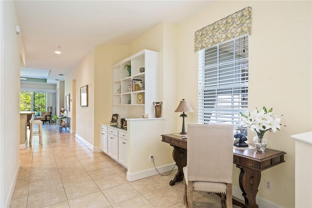 home office with light tile patterned floors and baseboards