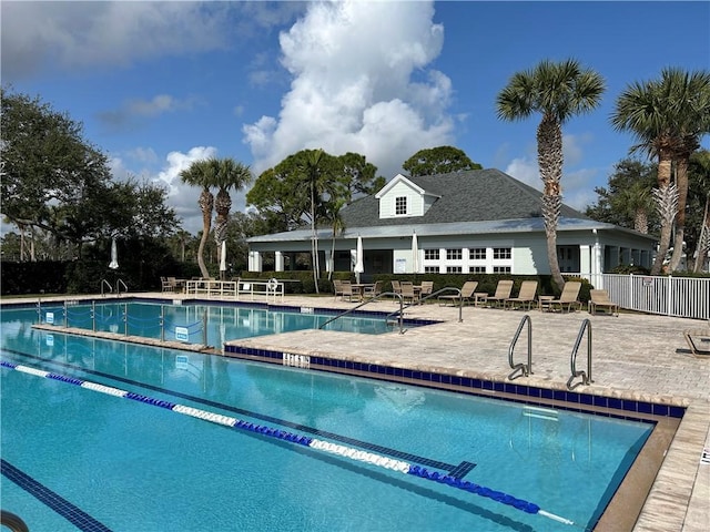 pool featuring a patio area and fence