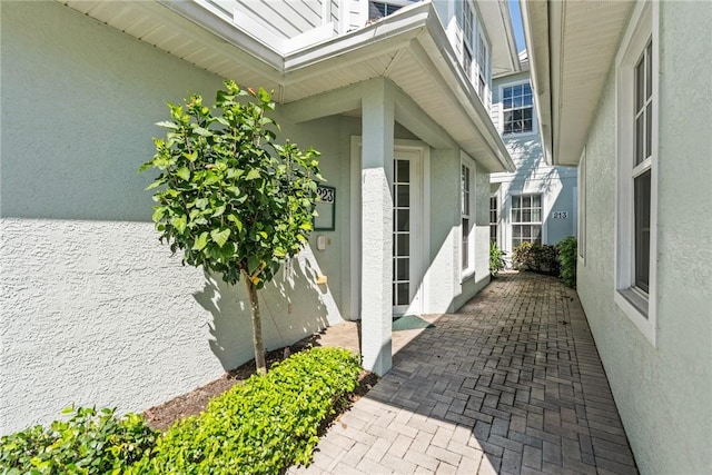 view of side of property featuring stucco siding and a patio