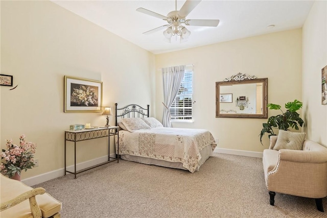 bedroom featuring baseboards, light carpet, and ceiling fan