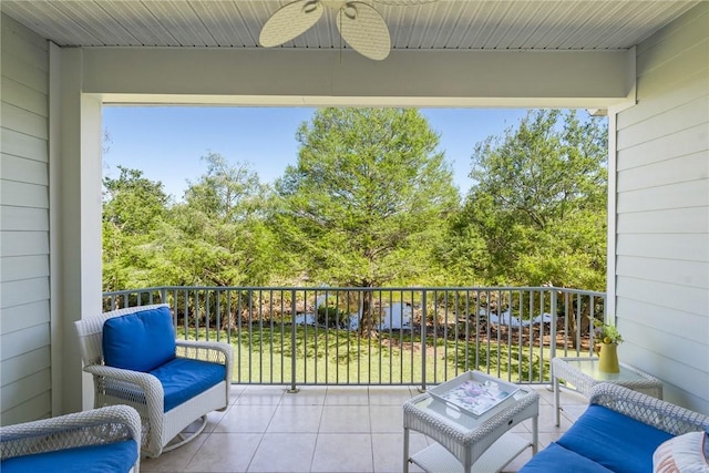 view of patio with a balcony and ceiling fan