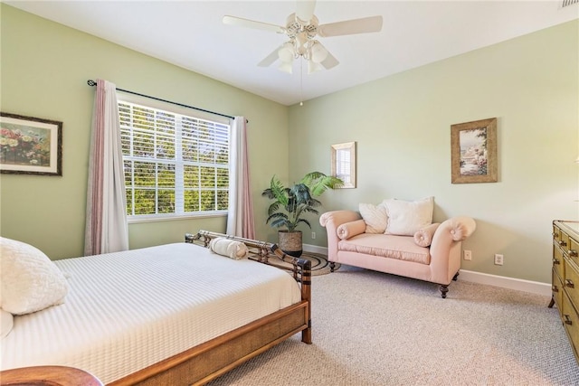 bedroom with baseboards, light carpet, and a ceiling fan