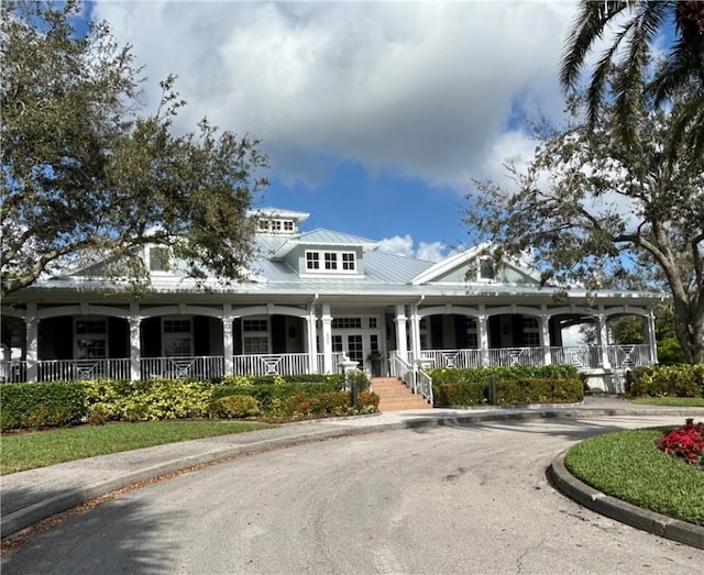 view of front of house with metal roof and a porch