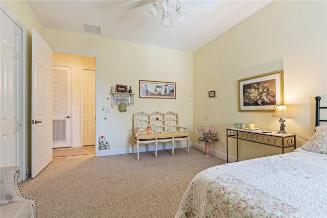 carpeted bedroom featuring visible vents, a ceiling fan, and baseboards