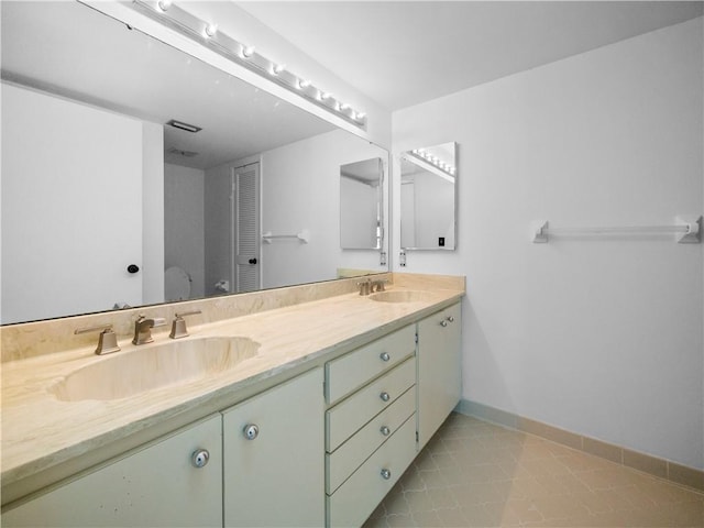 bathroom with vanity and tile patterned floors