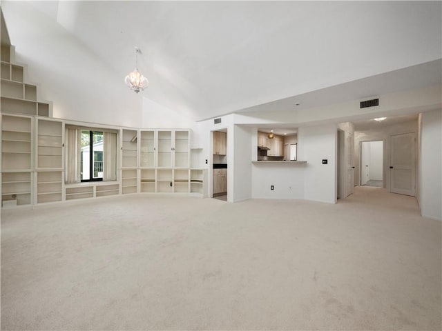 unfurnished living room featuring light carpet, high vaulted ceiling, and an inviting chandelier