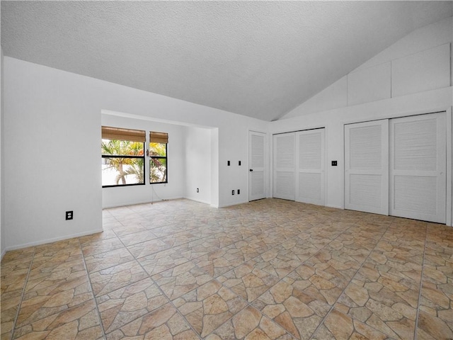 interior space featuring high vaulted ceiling and a textured ceiling