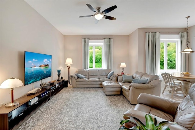 carpeted living area featuring a ceiling fan