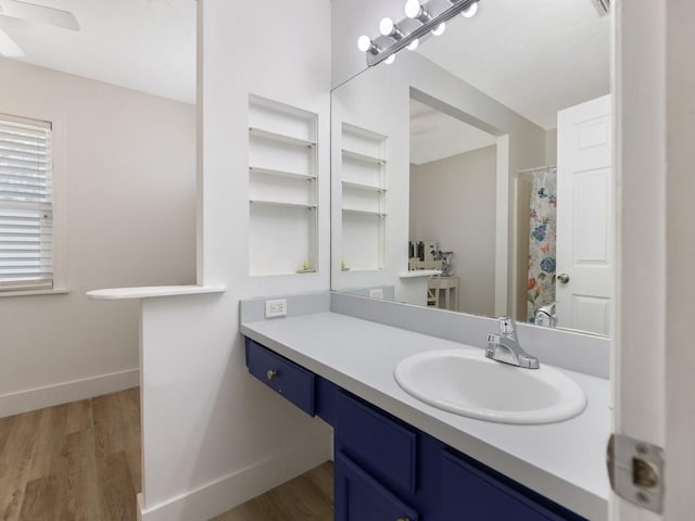 bathroom with hardwood / wood-style flooring, vanity, and a shower with curtain