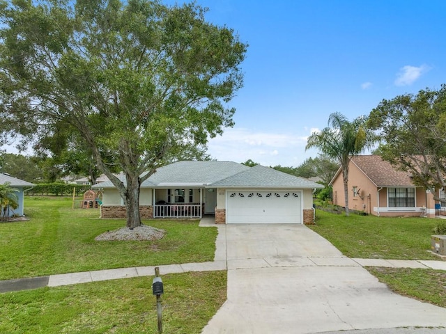 single story home featuring a porch, a garage, and a front yard