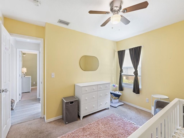 bedroom with light colored carpet and ceiling fan