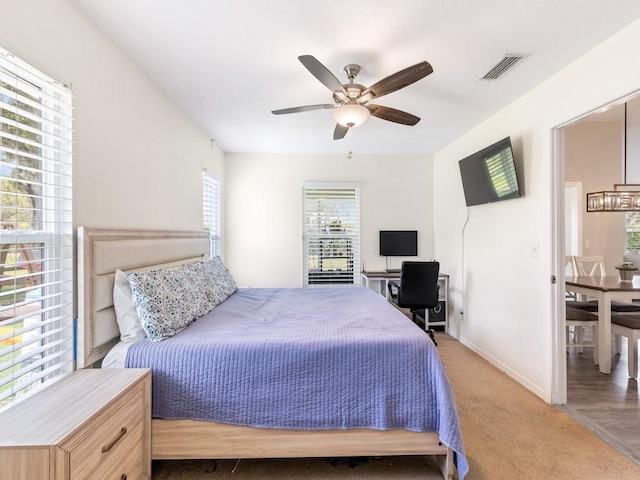 bedroom featuring light carpet and ceiling fan