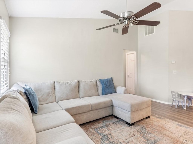 living room featuring ceiling fan, hardwood / wood-style floors, and high vaulted ceiling