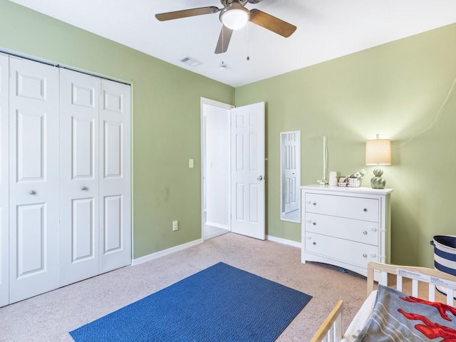 carpeted bedroom with ceiling fan and a closet