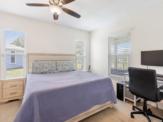 bedroom featuring ceiling fan and light colored carpet