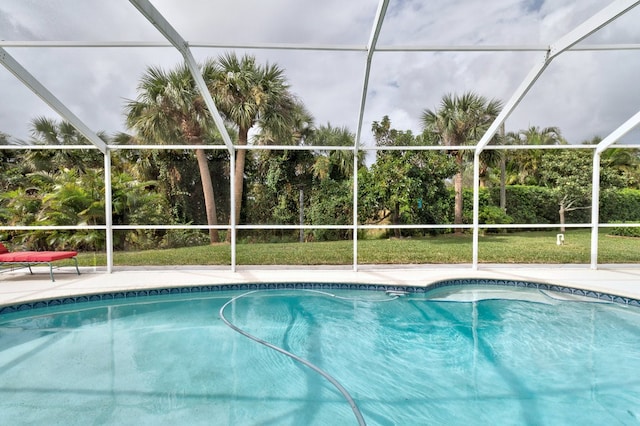 view of pool featuring glass enclosure and a patio