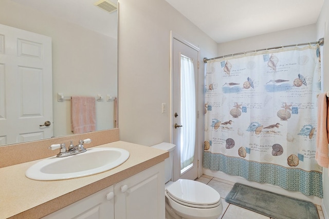 bathroom with vanity, curtained shower, tile patterned flooring, and toilet