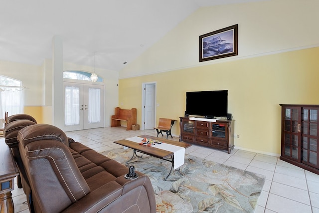 tiled living room with high vaulted ceiling and french doors